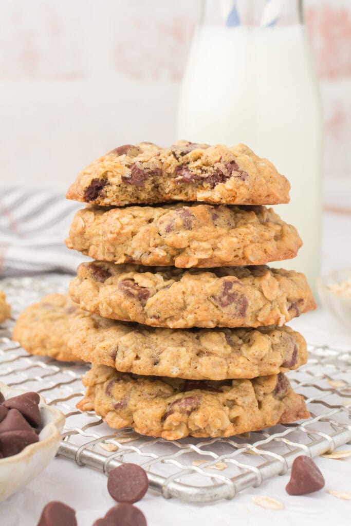 old fashioned oatmeal chocolate chip cookies stacked up with a bite taken out on top