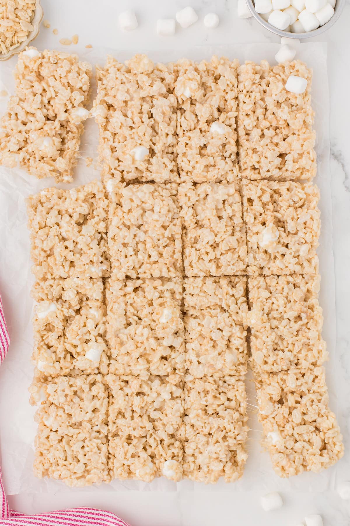 Rice Krispie squares laid out on a white countertop