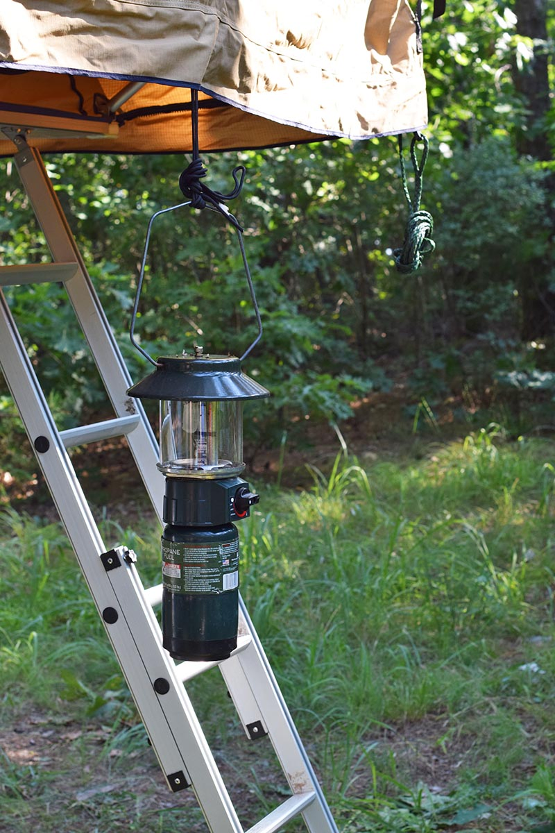 roof top tent ladder with hanging lantern and rope