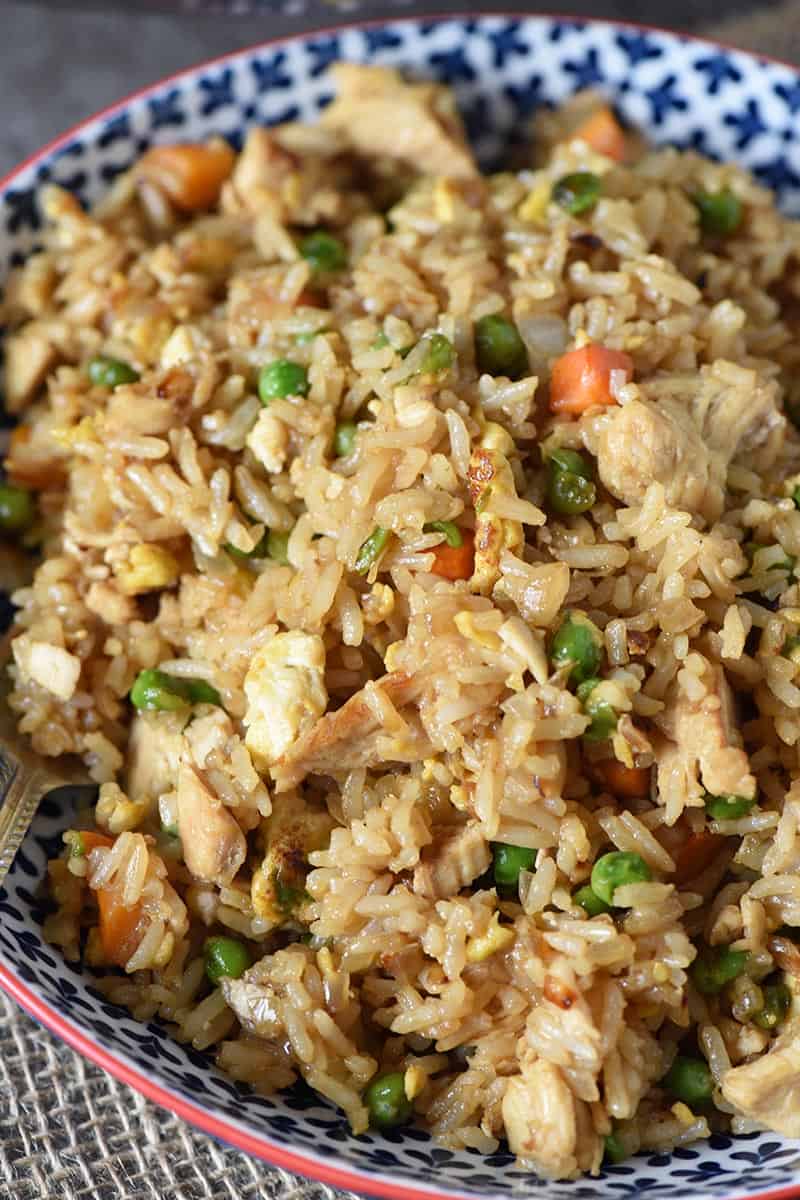 close up look of homemade chicken fried rice in a blue patterned bowl