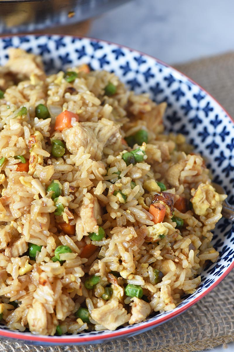 bowl of delicious Chinese chicken fried rice, homemade with eggs and vegetables
