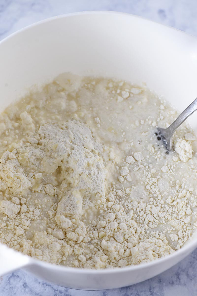 mixing batter for Bisquick sweet biscuits recipe in white mixing bowl
