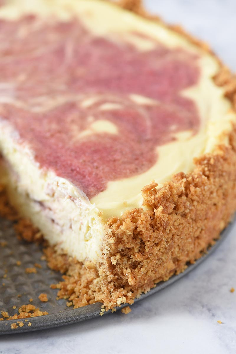 homemade graham cracker crust with strawberry swirl cheesecake