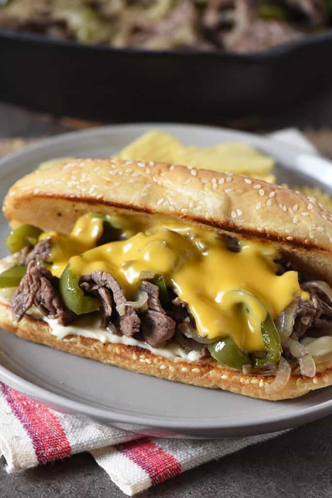 Philly cheesesteak with Cheez Whiz, sirloin steak, peppers, onions, and mushrooms