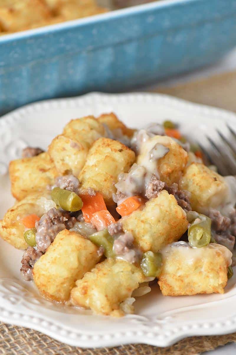 easy tater tot casserole with veggies served on white plate with fork