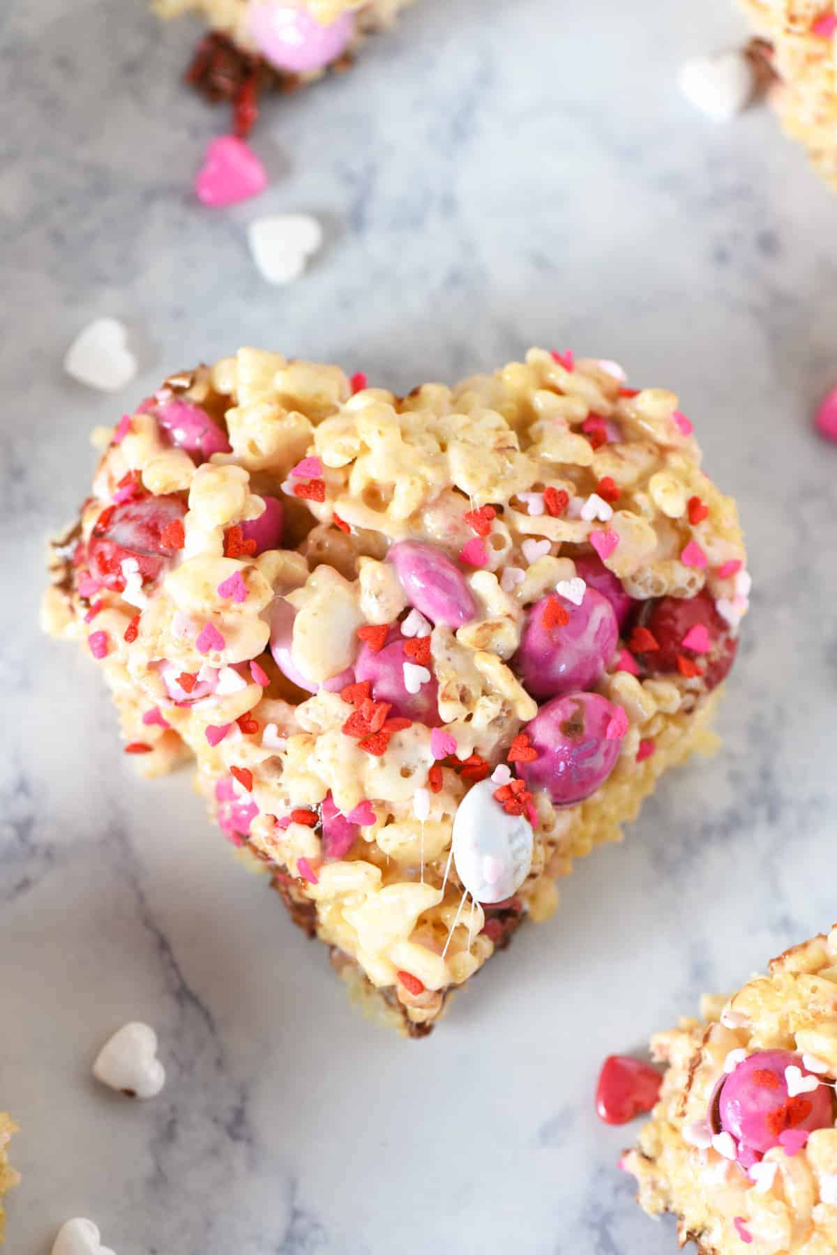 Valentine's Day Rice Krispies treat with M&M's on white marble countertop