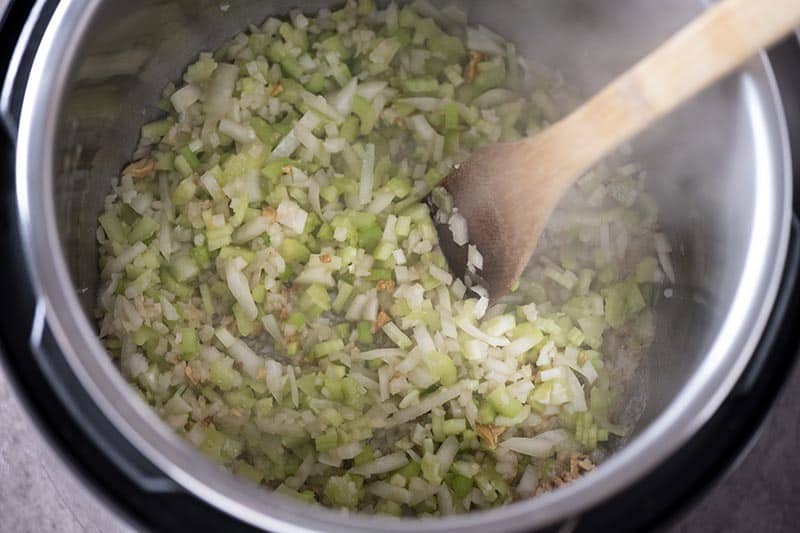 celery, onions, and garlic sautéing in the Instant Pot