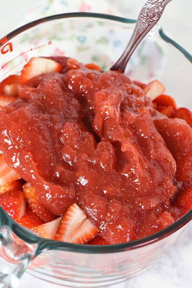 mixing strawberries with strawberry pie filling for strawberry dessert
