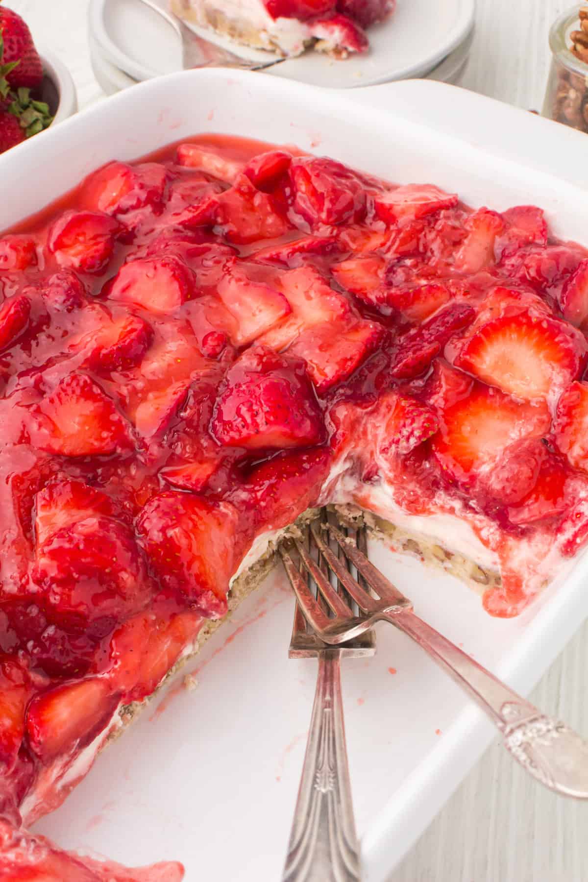 strawberry delight dessert in a 13x9 white baking pan
