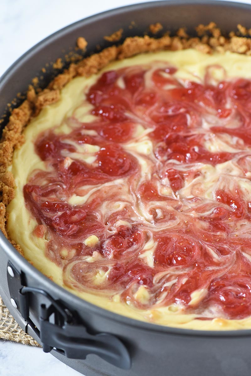 baked strawberry swirl cheesecake in springform pan