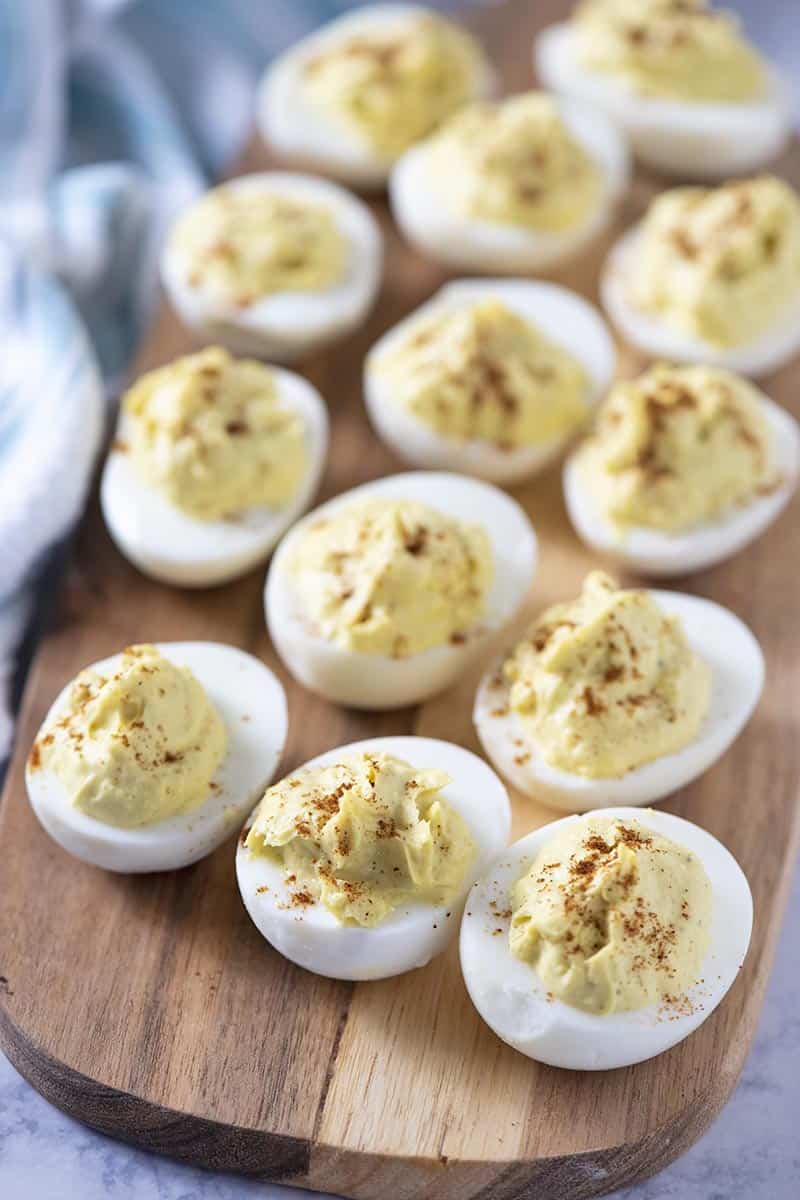 classic deviled eggs on a wooden cutting board