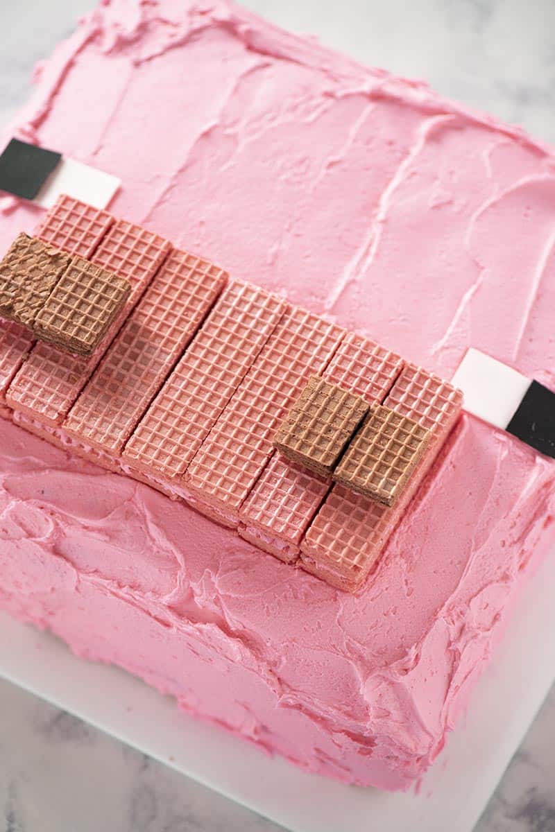 pink Minecraft pig cake on white cake board