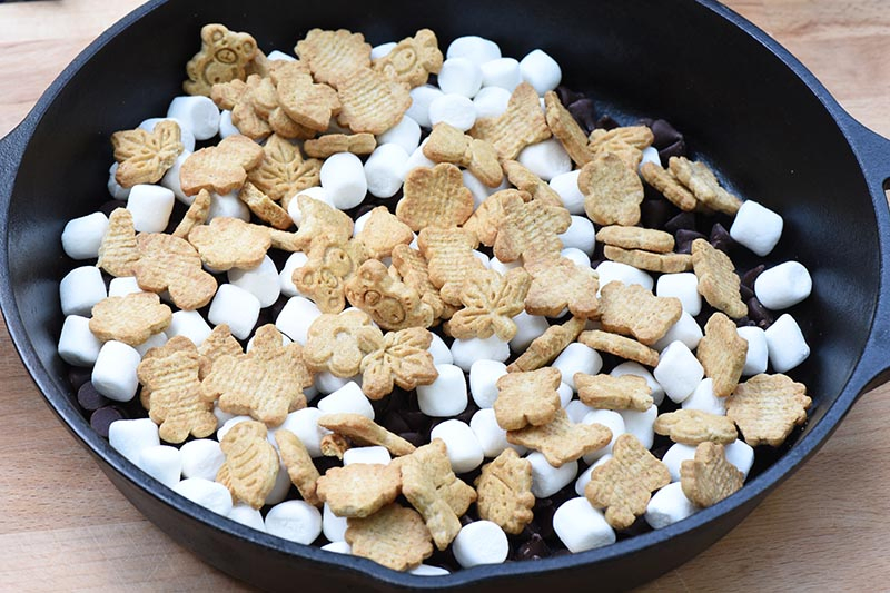 s'mores in a pan made with Teddy Grahams Outdoor Discoveries crackers, chocolate, and marshmallows