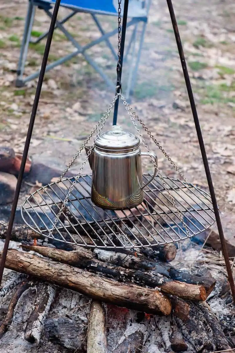 making coffee over campfire on tripod grill, campfire cooking