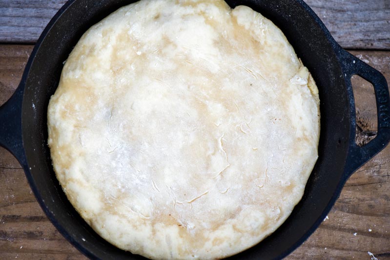 homemade pizza crust in cast iron skillet