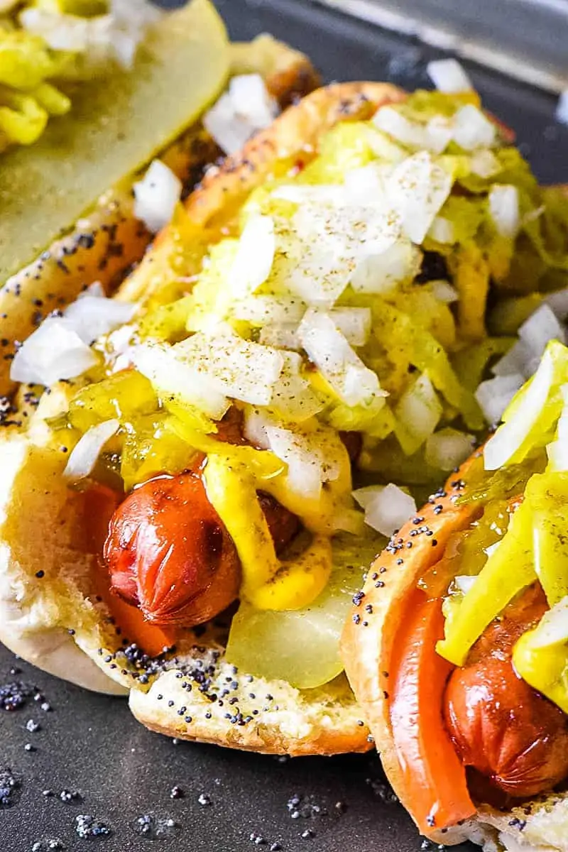 Chicago dog with toppings on baking sheet