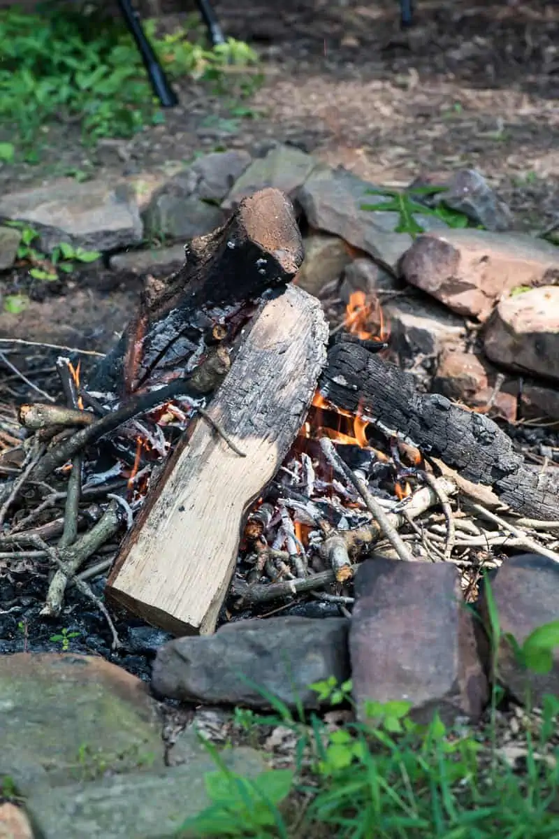 teepee fire in camp fire pit, built with homemade fire starters