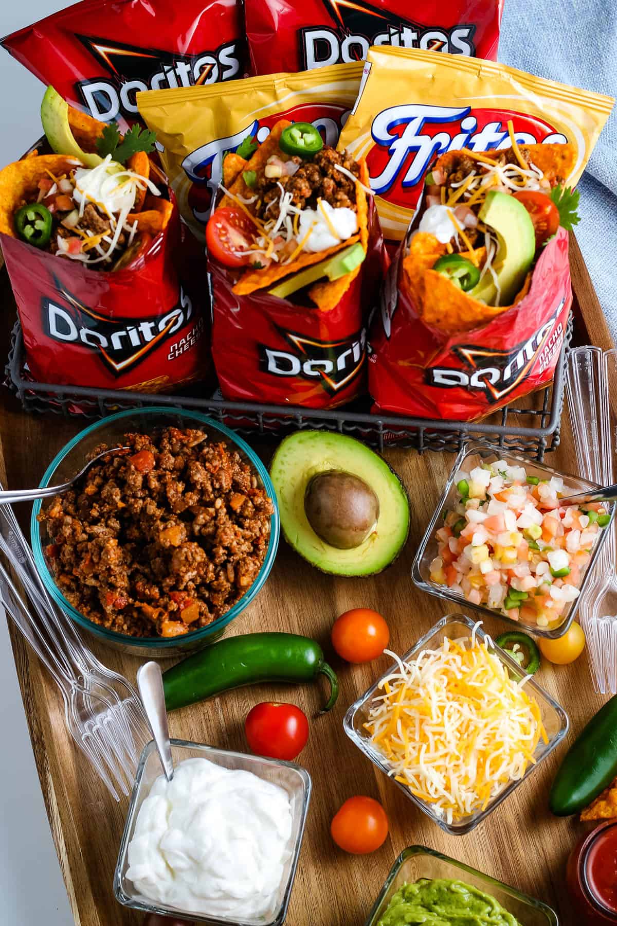 camping walking tacos and ingredients on wood cutting board