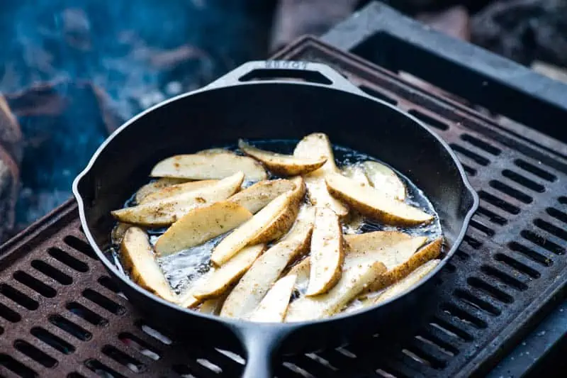 how to make steak fries by cooking in cast iron skillet on campfire grill 
