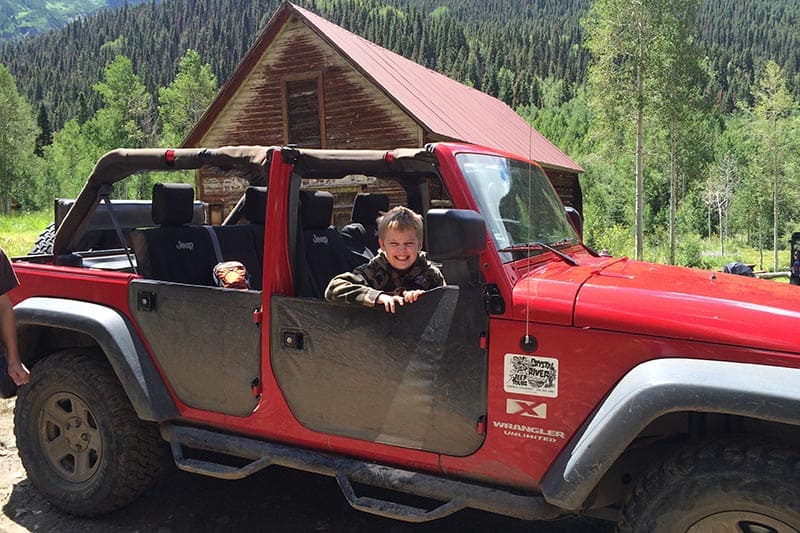 boy sitting in Big Red, one of the heavy duty Jeeps operated by Crystal River Jeep Tours