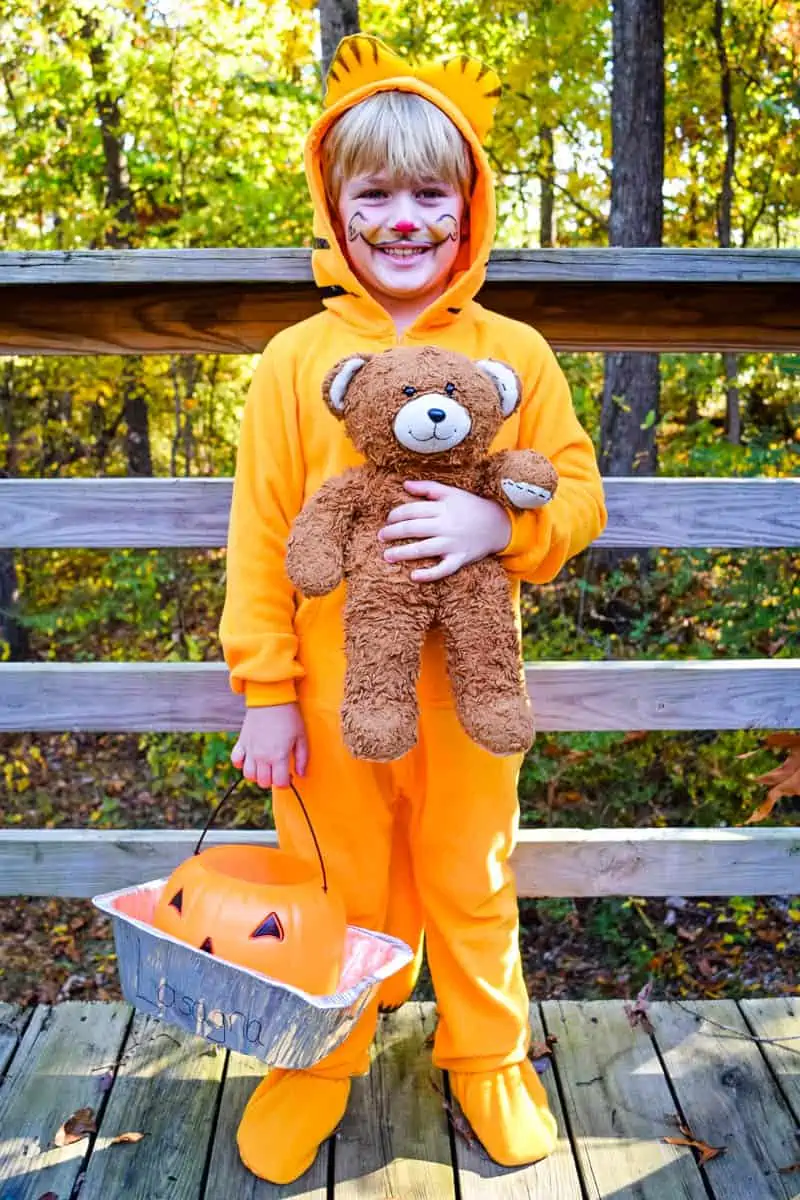 boy in Garfield costume with stuffed Pooky the Teddy Bear and lasagna pan with trick or treat bucket
