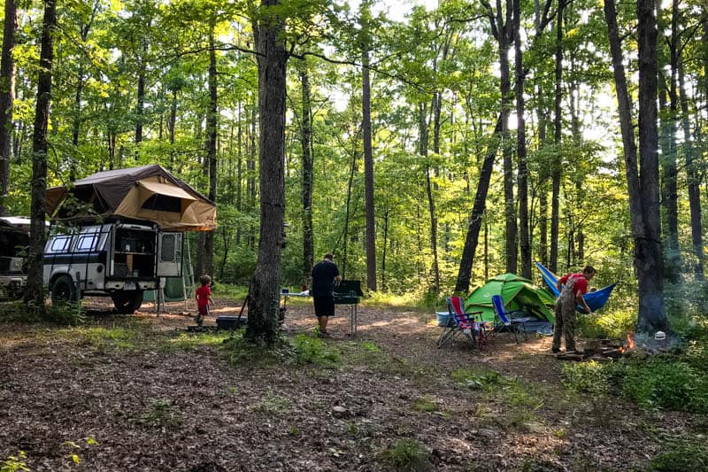 people in Ozark National Forest camping site with rooftop tent and ground tent and hammock
