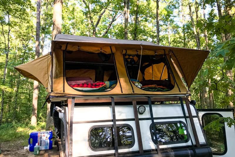 camping in Arkansas in tan rooftop tent on camping trailer