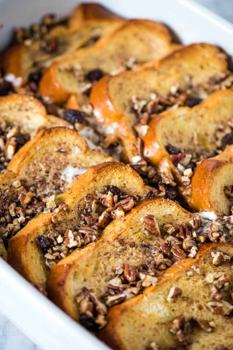 brioche French toast bake with pecans and raisins in white baking dish
