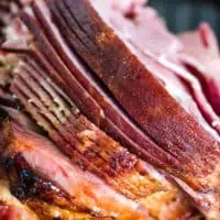roasted spiral cut bone-in ham in roasting pan