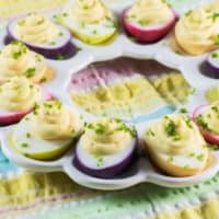 rainbow deviled eggs on white egg platter