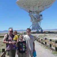 mom and kids standing in front of large satellite at Very Large Array in New Mexico, USA