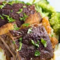 slow cooker beef ribs on white plate with broccoli