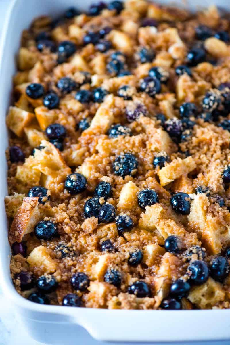 overnight blueberry French toast with streusel topping baked in white baking dish