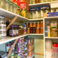 working prepper pantry full of shelf-stable canned food and supplies