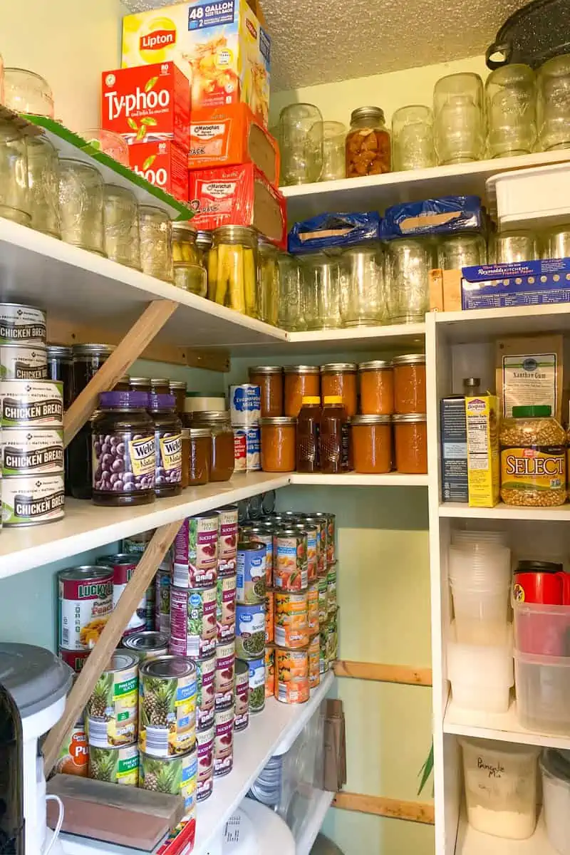 working prepper pantry full of shelf-stable canned food and supplies