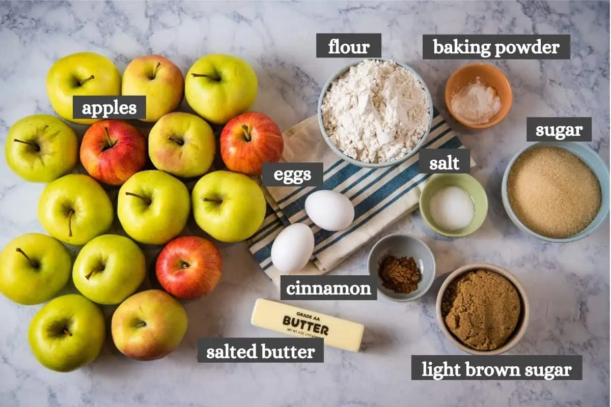 ingredients for making apple crumble recipe on white marble countertop