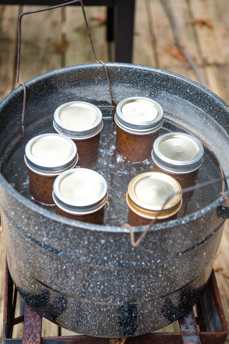 canning homemade apple butter in hot water bath in large enamel water bath canner