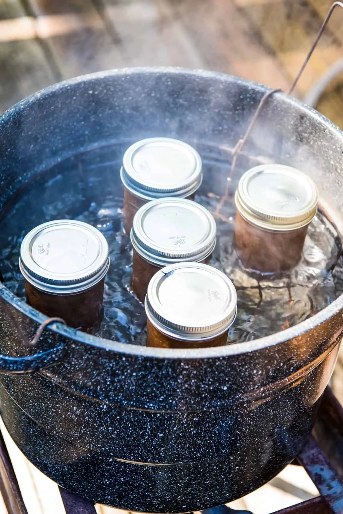hot water bath canning jars of apple butter in water bath canner