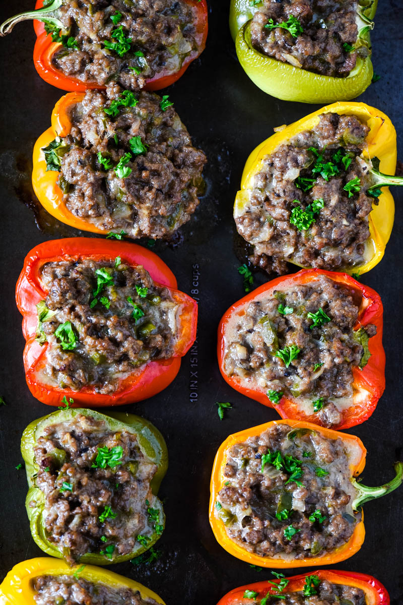 baked Philly cheese stuffed peppers, sprinkled with parsley, on baking sheet