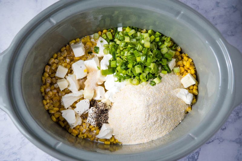 CrockPot corn casserole ingredients in gray slow cooker