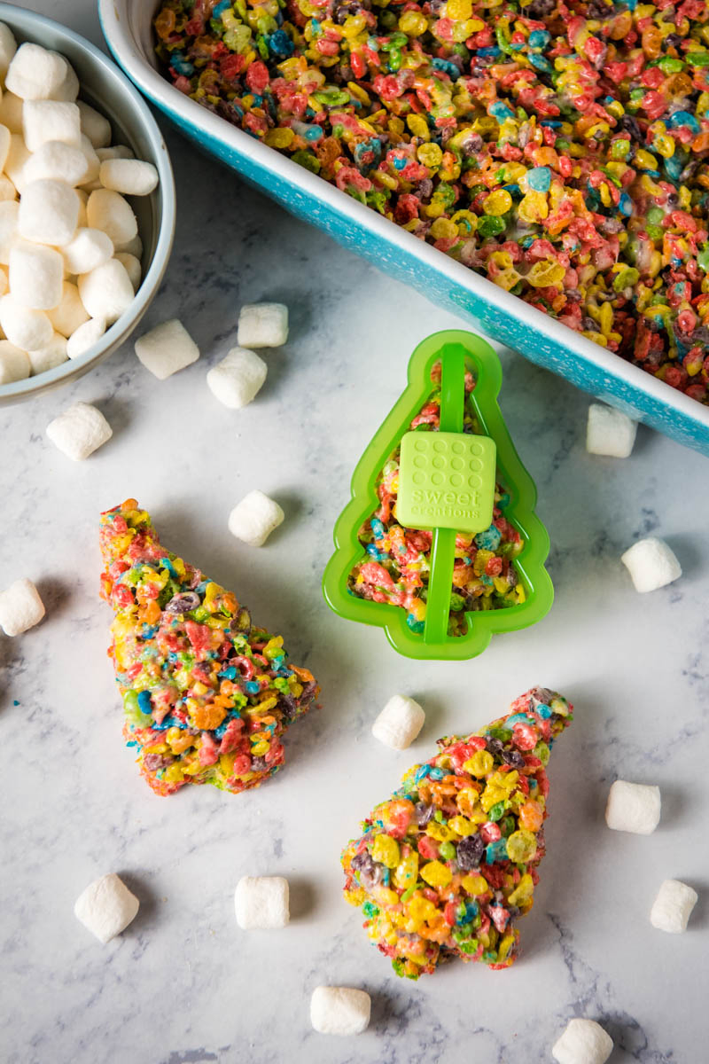 Fruity Pebble Christmas trees with Christmas tree cookie cutter and mini marshmallows on white marble countertop