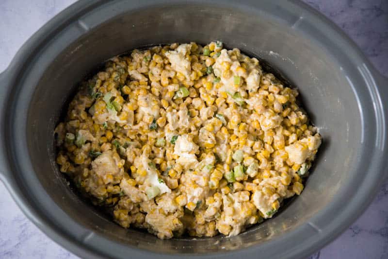 stirred ingredients for Crock Pot corn casserole in gray slow cooker
