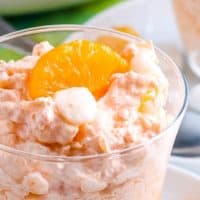 mandarin orange jello salad in plastic cup for serving