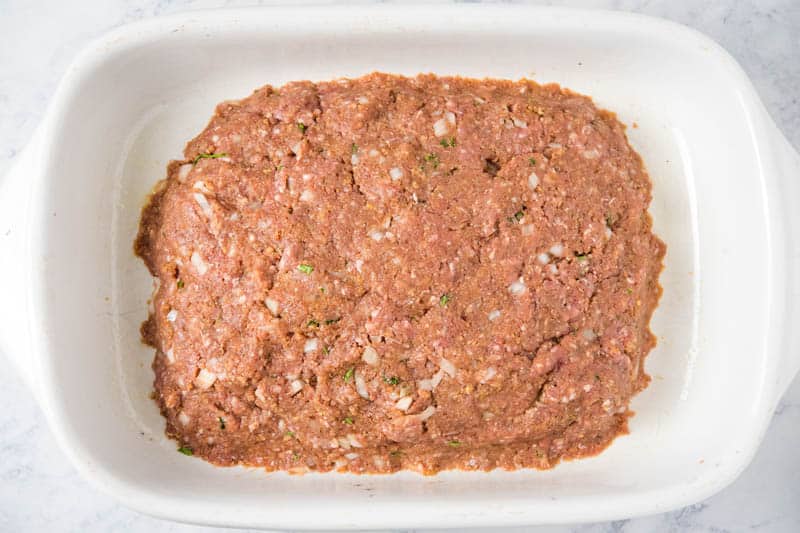 shaped meatloaf in white baking dish