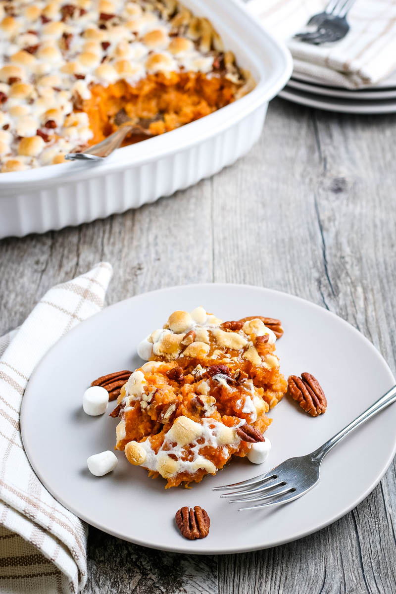 serving of sweet potato and marshmallow casserole on gray plate with fork