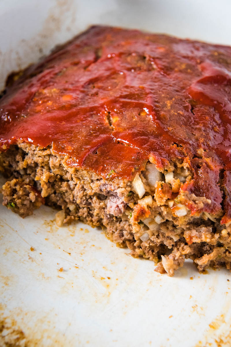 sliced traditional meatloaf in white baking dish