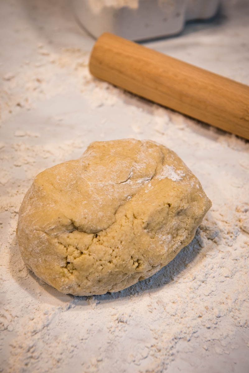 dough for soft cut out sugar cookies on floured surface with rolling pin