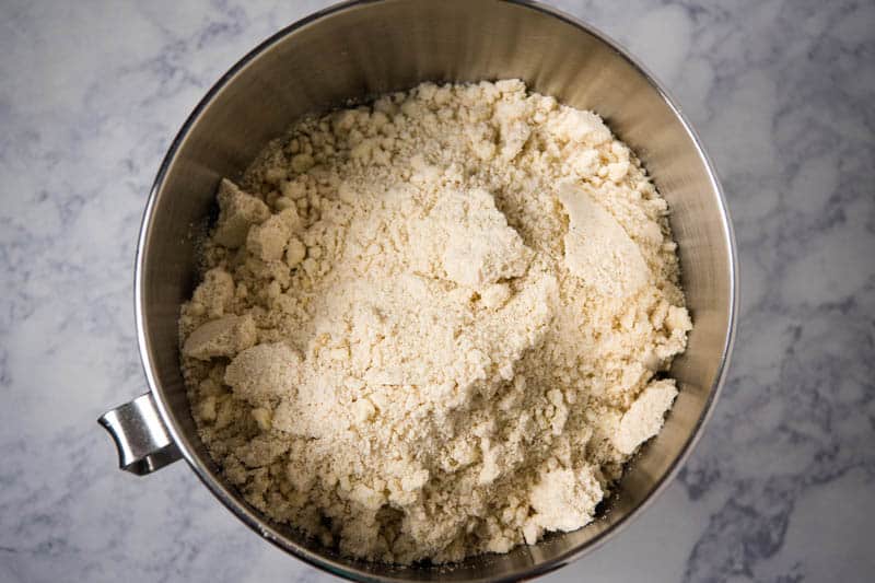 dry ingredients added to liquid ingredients for sugar cookies in large bowl