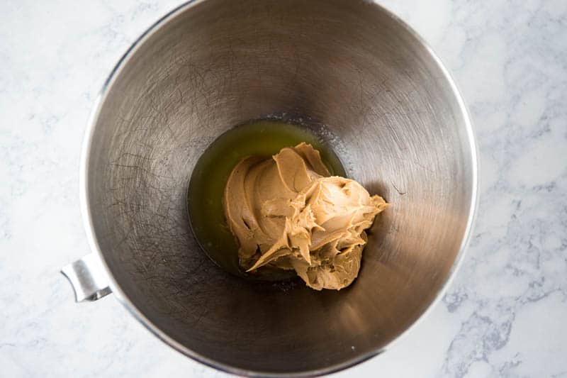 peanut butter and melted butter in KitchenAid mixing bowl