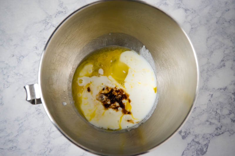 combining buttermilk with vanilla extract and eggs in large KitchenAid mixing bowl